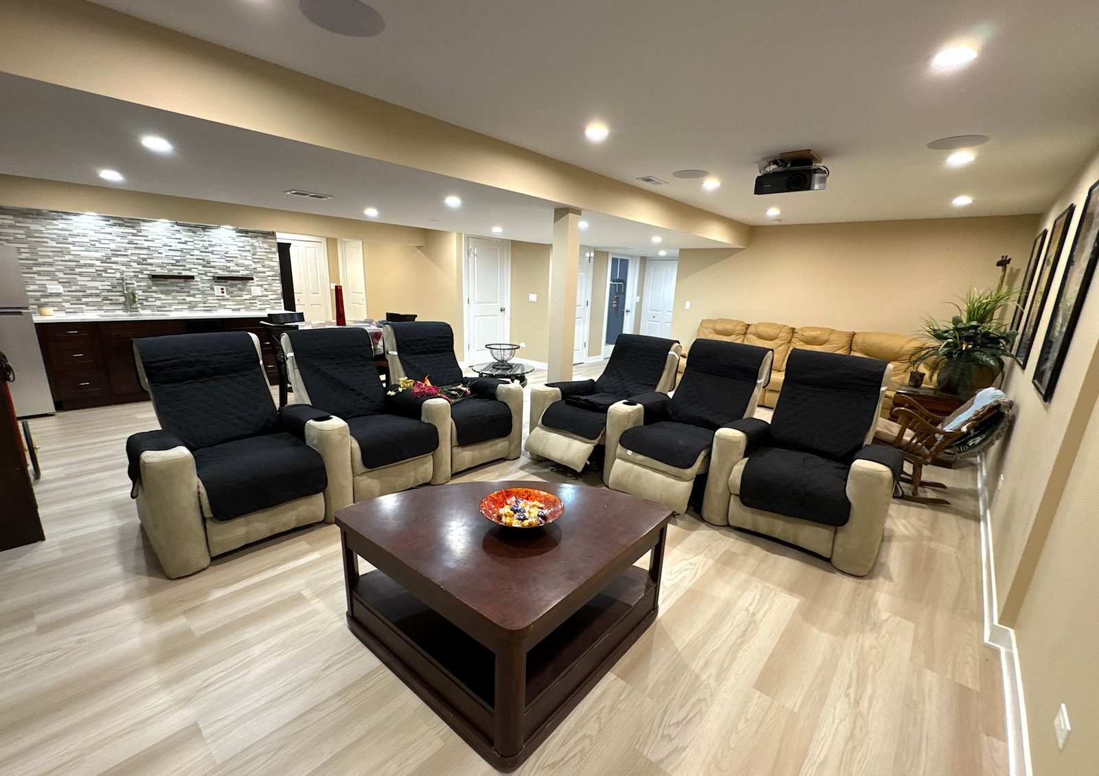 Basement theater seating with wet bar and projector