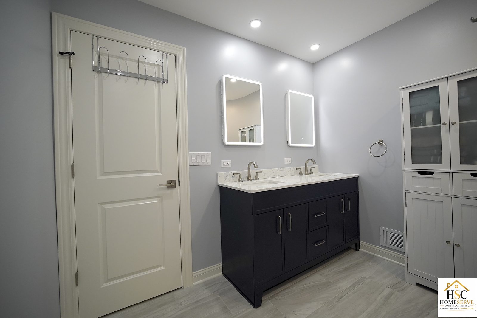 Gurnee bathroom - finished navy double vanity with backlit mirrors