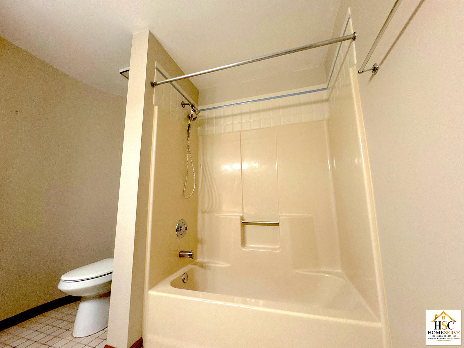 Gurnee bathroom - original almond tub and shower surround with toilet