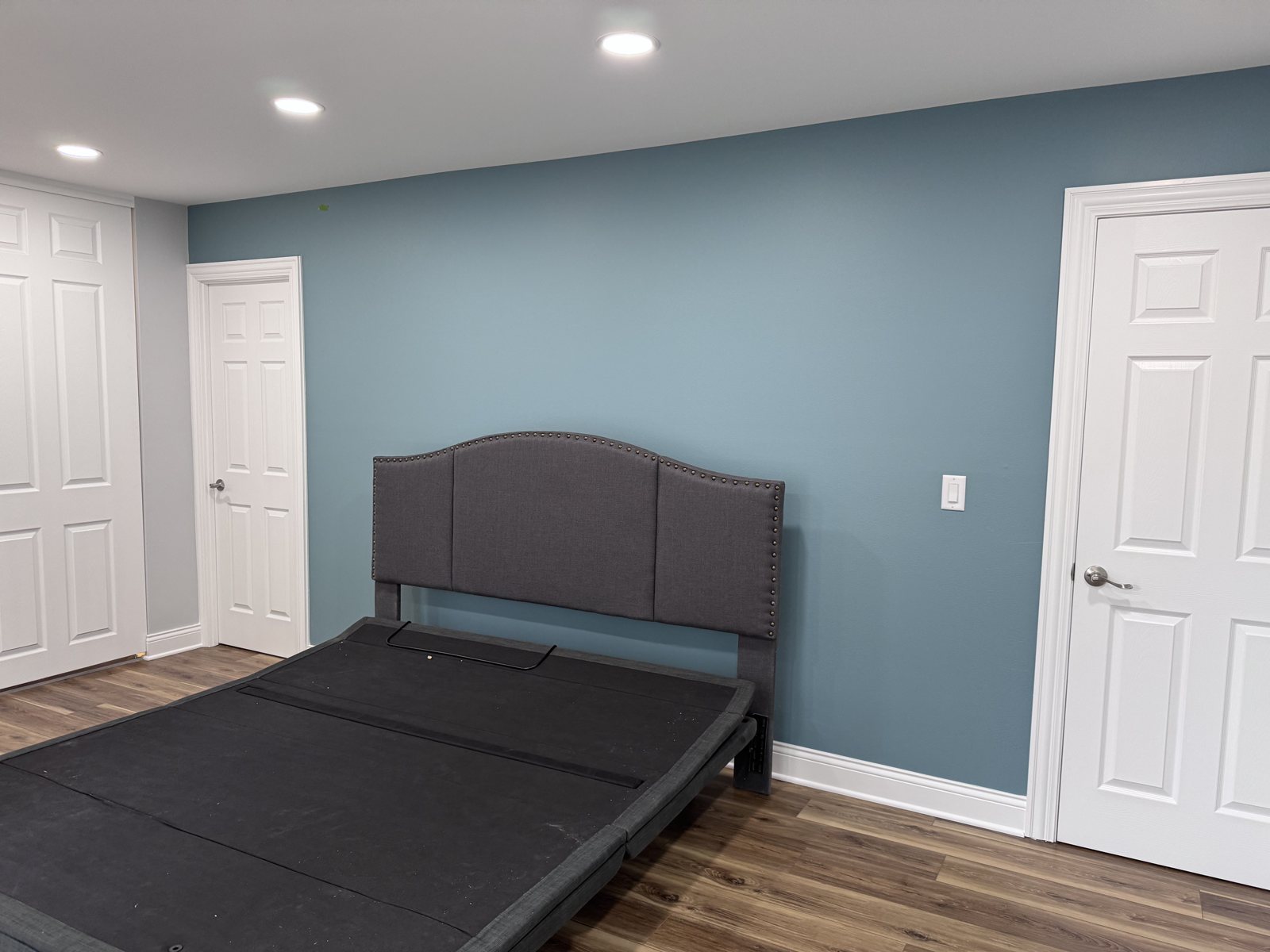 Hanover Park bedroom after: wood-look floor and blue accent wall