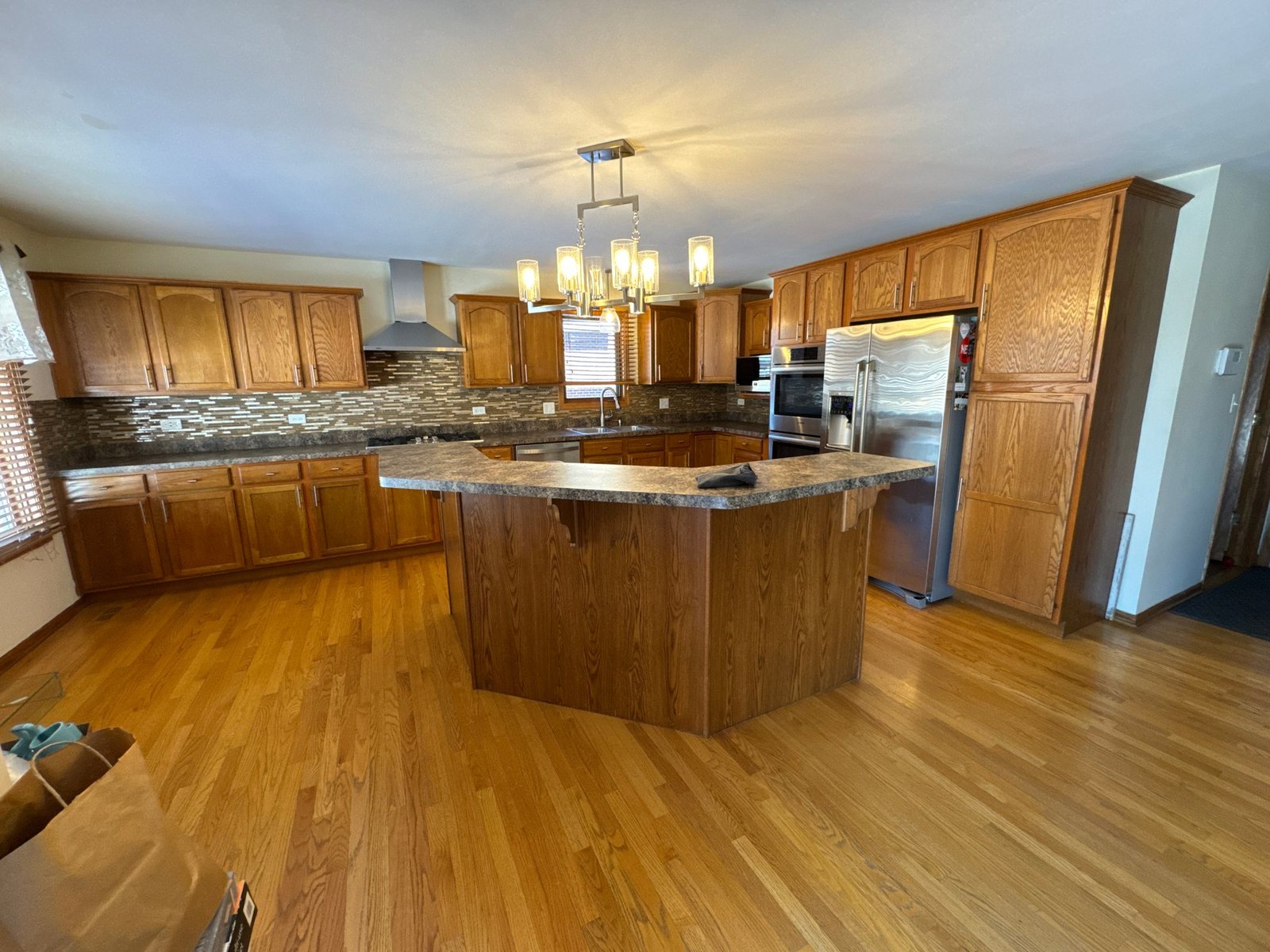 Kitchen before the remodel: oak cabinets and laminate island