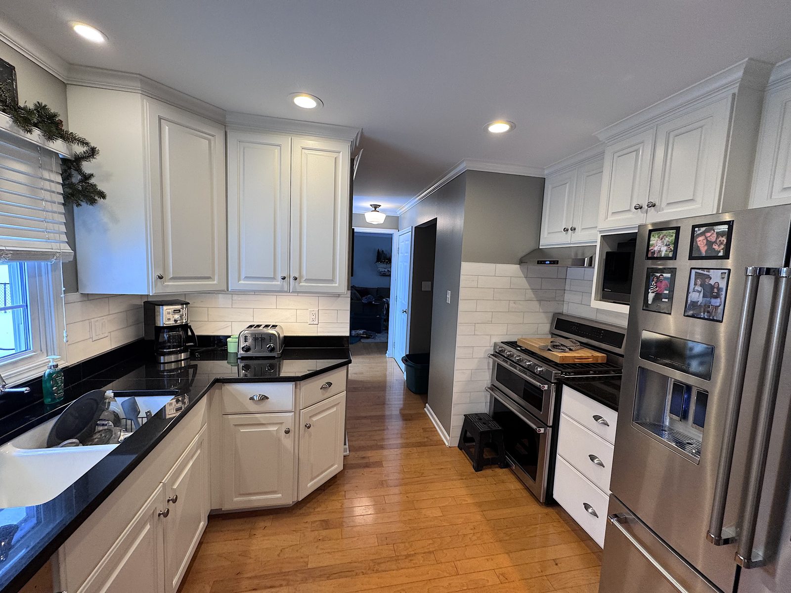 Bronze kitchen: white cabinets, new countertops and tile backsplash in the existing layout