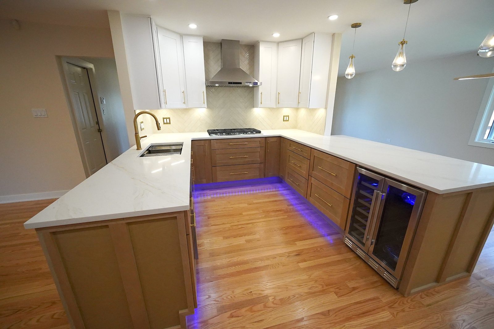 U-shaped kitchen with wine fridge and LED toe-kick lighting