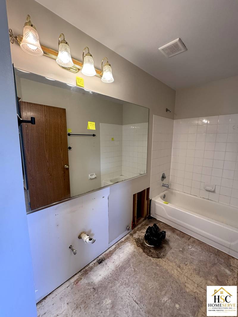 Original vanity, mirror, and alcove tub