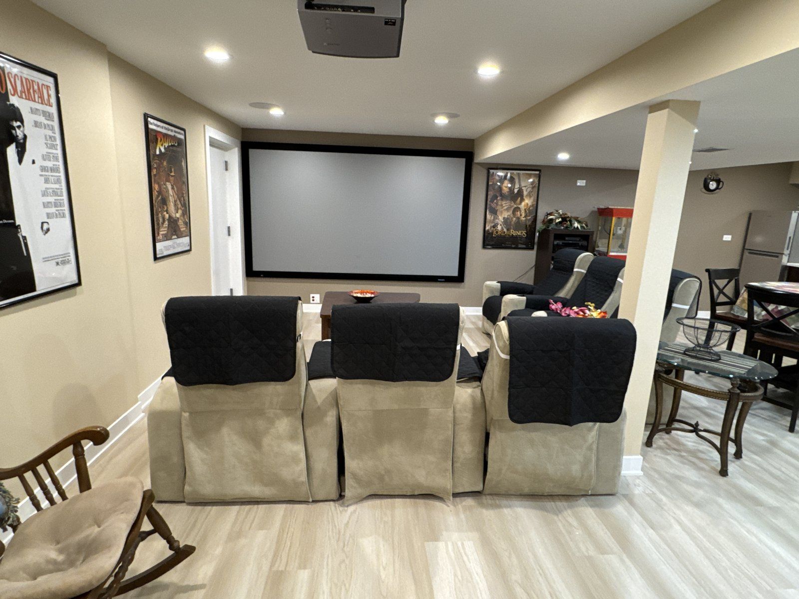 Basement home theater with projector screen and reclining seats