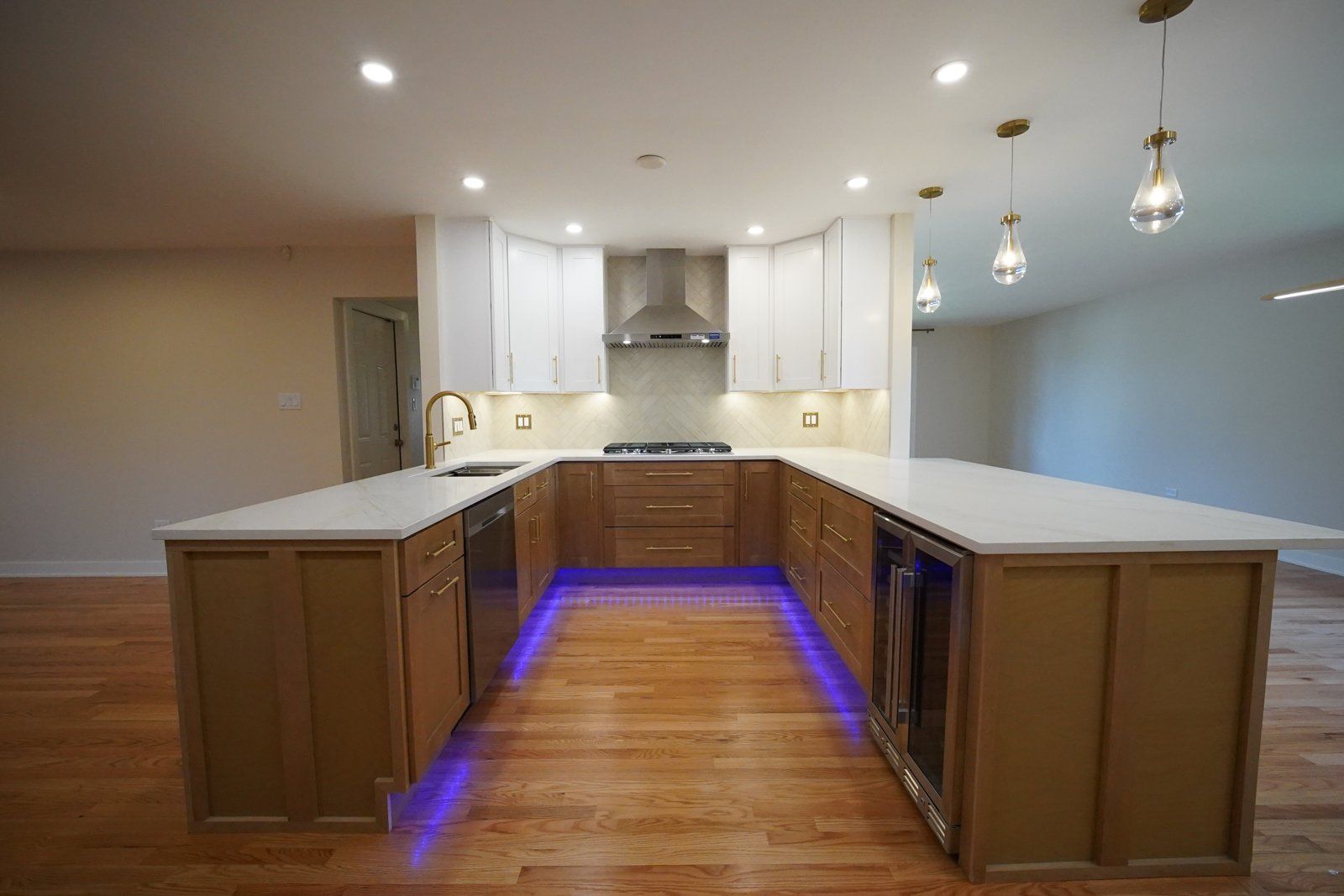 Finished navy island kitchen with blue LED lighting