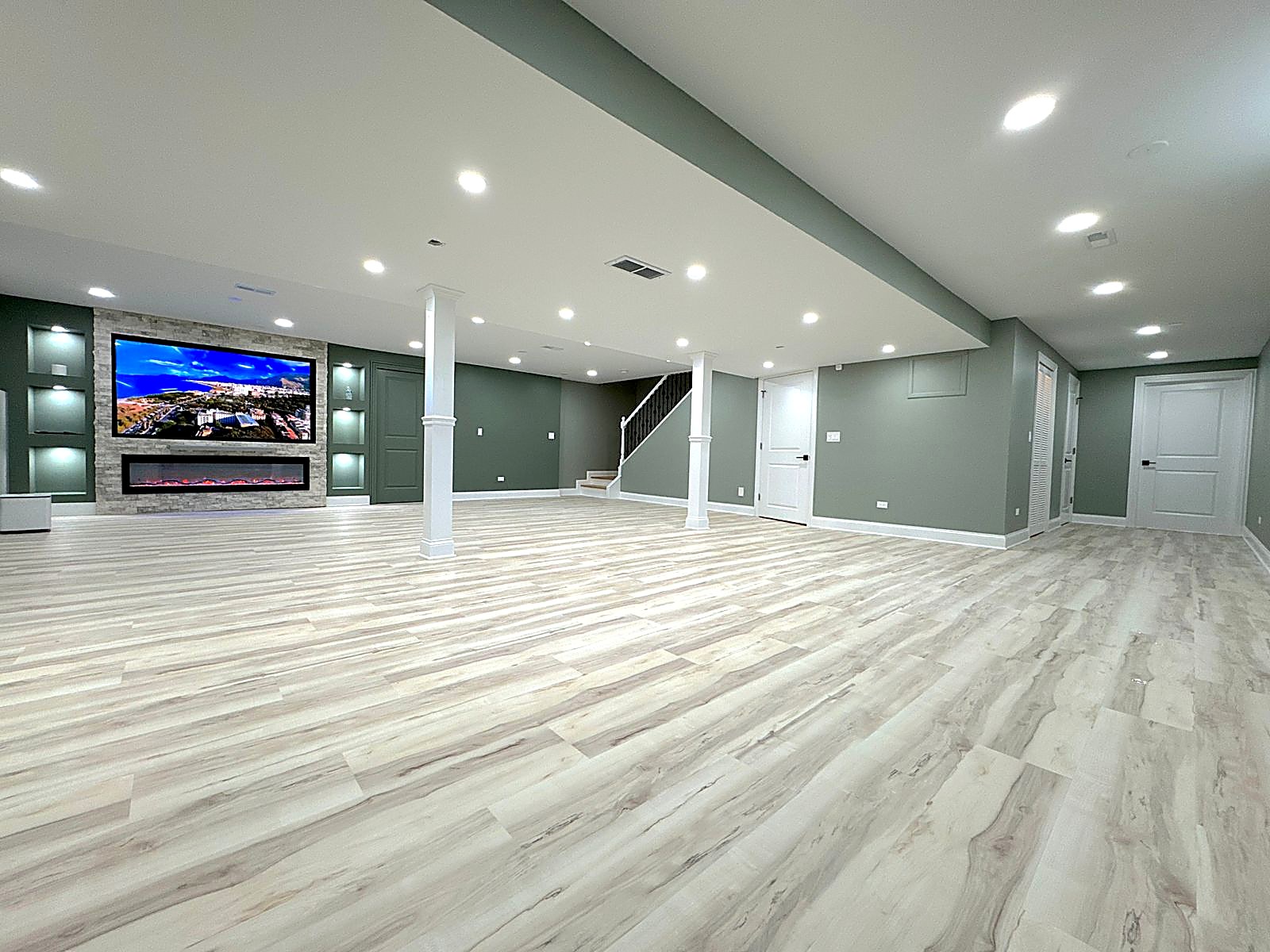 Finished basement with stone fireplace wall